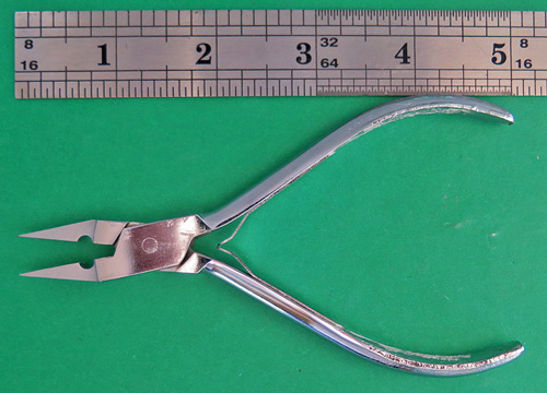 #LONGNIBPLIERS: LONG HANDLE PLIERS FOR WORKING ON NIBS. SAME SIZE JAWS AS OUR ORIGINAL 3" NIB PLIERS, BUT WITH LONGER HANDLE. NO SERRATIONS ON THE INSIDE SURFACES OF JAWS. MADE OF CHROME PLATED STEEL WITH BOX JOINTS.